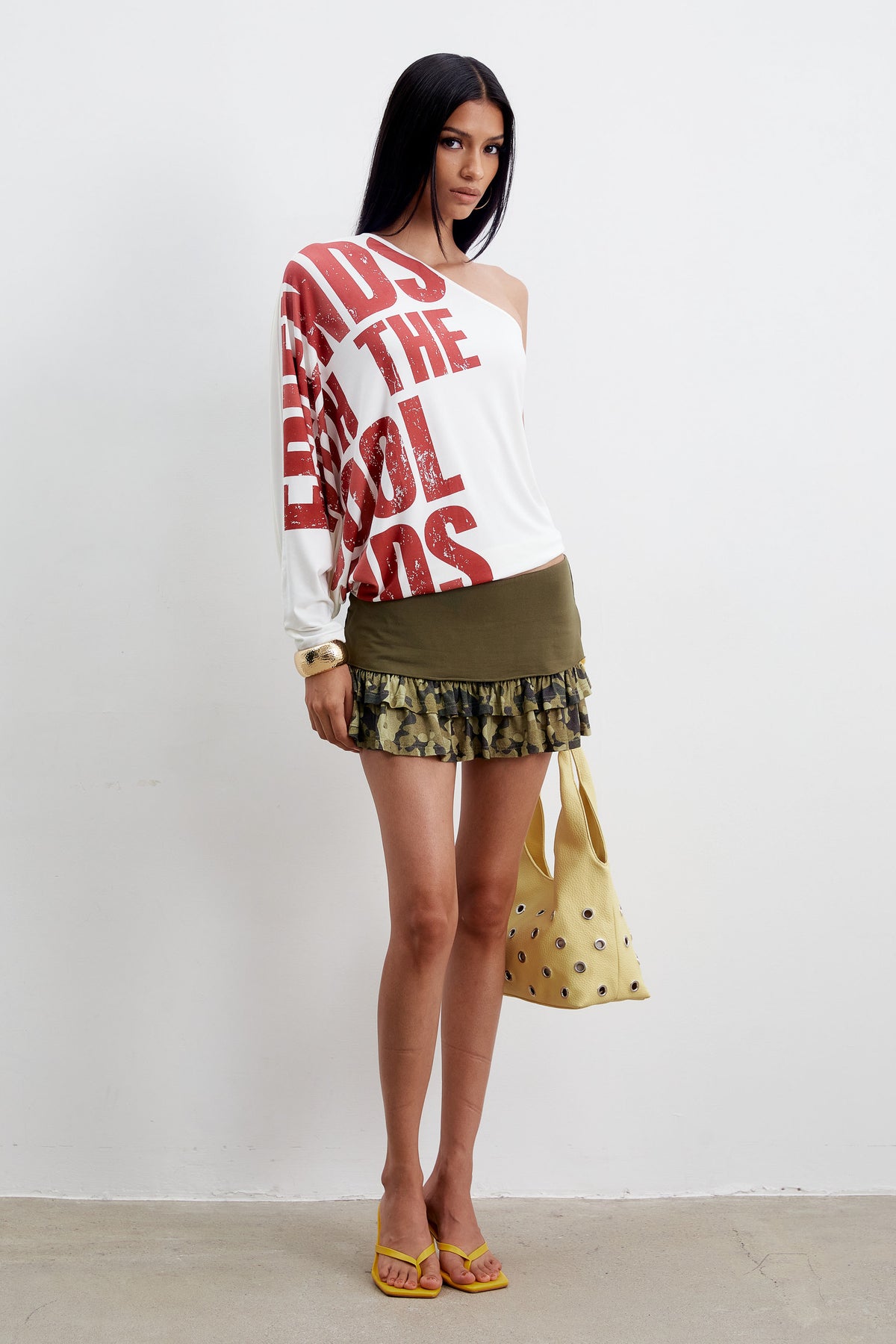 Three-quarter view of the Eli Top with the red slogan print across the sleeve