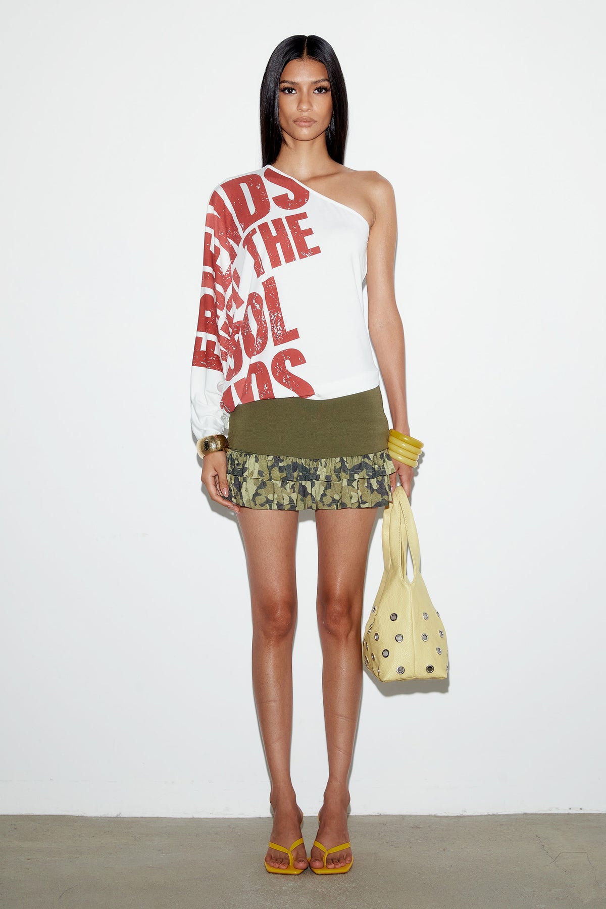 Front view of the Eli Top showing the bare shoulder and long single sleeve