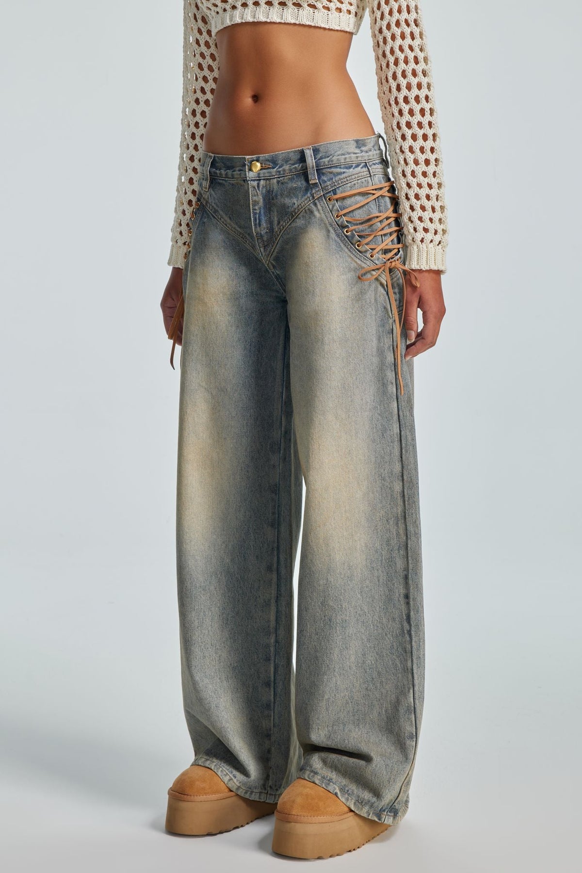 Front view of the Regan Jeans low-rise waist styled with a knit top and platform boots